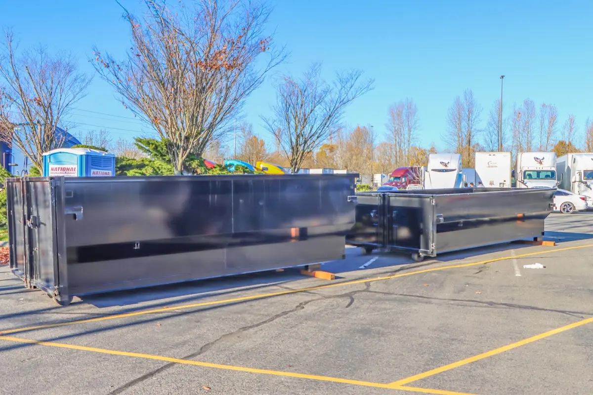 Professional dumpster rental service with roll-off container on residential driveway in Kearns